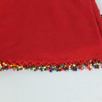 Red scarf with crocheted bead edges..